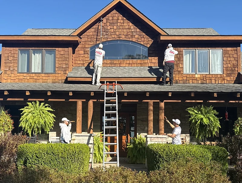 PTL Painting crew of four professionals painting a large two-story cedar shake home in Northwest Indiana