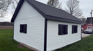 Wooden shed painted white with black trim after exterior painting Indiana