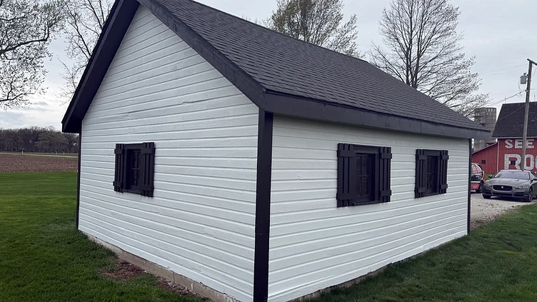Wooden shed painted white with black trim after exterior painting Indiana