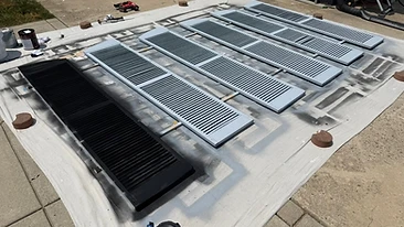 Spray painting exterior shutters black and grey Indiana
