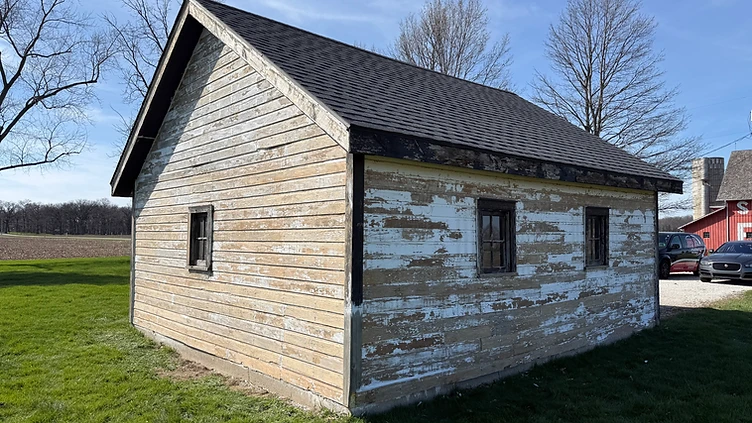 Wooden shed with peeling paint before exterior painting Indiana