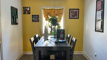 Dining room with mustard yellow accent wall interior painting Indiana