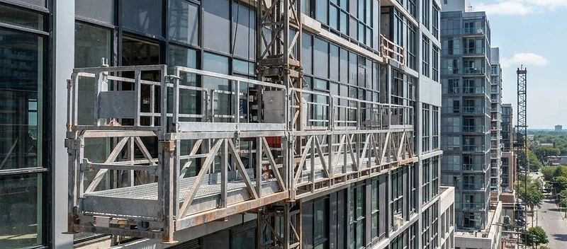 Mast climber work platform on a vertical mast