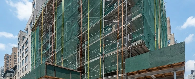 Safety lifelines, debris netting, and sidewalk protection on a site