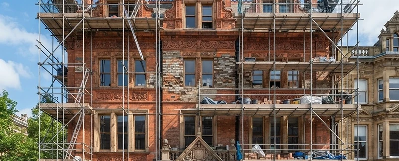 Historic heritage building undergoing restoration with scaffolding