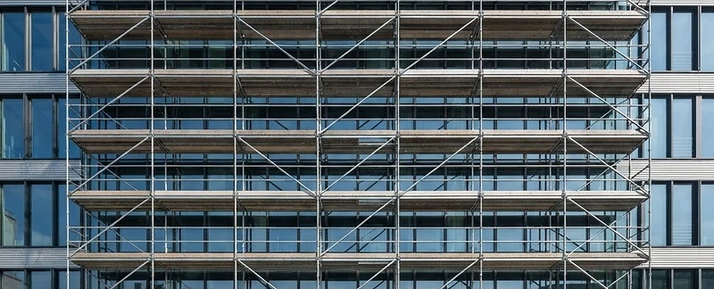 Galvanized steel system scaffold against a commercial building