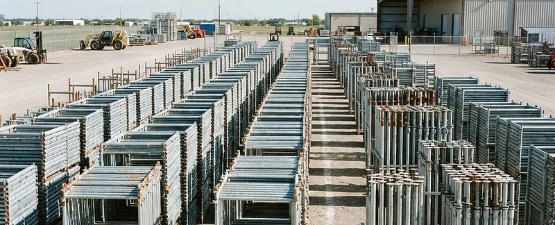 Scaffold frames and shoring posts organized in an equipment yard