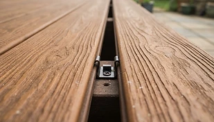 Close-up of composite decking board with realistic wood grain and hidden fastener