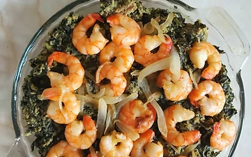 Authentic bowl of Cameroonian Ndolé — bitter leaves and ground peanut stew with shrimp, peanuts and lime