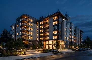 Modern multifamily apartment building exterior at dusk