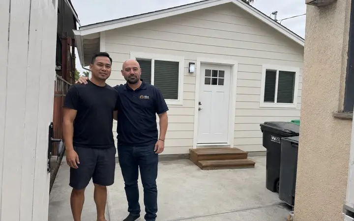 Homeowner with the IBA Builders representative in front of a finished garage conversion ADU