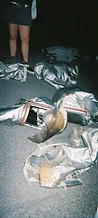 Discarded 8-BIT silver fire hood and suit on the asphalt at JescoFest 2006