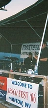 The Transmission three-piece band performing on the wooden stage at JescoFest 2006