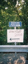 Hand-lettered JescoFest 2006 sign with arrow by the Meadow Creek Baptist Church sign