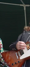 Frontman with a snake around his neck and guitarist performing together at JescoFest 2006