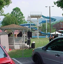Festival scene with gazebo, water slide and crowd at JescoFest 2006