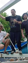 Three men posing on the blue water slide structure at JescoFest 2006
