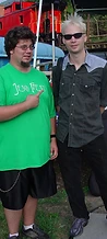 Jesco Fest staff member in green shirt pointing at Tazz Toni by the festival stage at JescoFest 2006