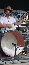 J. Glenn singing and playing banjo in front of the bass drum at JescoFest 2006