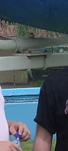 Two men posing together in front of the blue water slide at JescoFest 2006