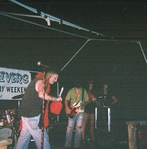 Singer holding a red gas can on the Festival of the Rivers stage at JescoFest 2006