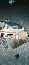 Discarded 8-BIT silver fire hood lying on the asphalt at JescoFest 2006