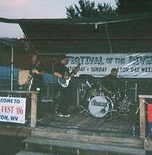 The Transmission performing on the outdoor stage with Festival of the Rivers banner at JescoFest 2006