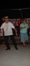 Unkl Ray's crew member dancing with a woman on the JescoFest 2006 stage at night