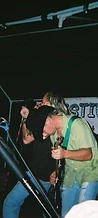 Guitarist in a cowboy hat performing under stage lights at JescoFest 2006