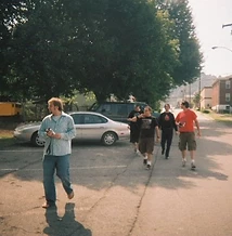 Four men walking across the parking lot at golden hour at JescoFest 2006