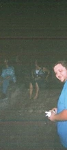 Man in a blue shirt looking at a camera at night at JescoFest 2006