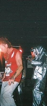 Festival goer in a red tank top with an 8-BIT silver-suited performer at JescoFest 2006