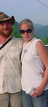 Bearded man in a safari hat and a blonde woman posing together in the parking lot at JescoFest 2006