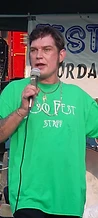 Jesco White singing into a handheld mic with arm raised at JescoFest 2006