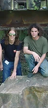 Four-piece band posing by a rock beneath a bridge at JescoFest 2006