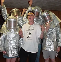 8-BIT in silver fire-entry suits posing with an Unkl Ray's crew member indoors at JescoFest 2006