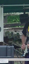 Guitarist wearing a yellow lei playing a white electric guitar on Sunday at JescoFest 2006