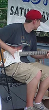 Guitarist in a red cap playing a sunburst Stratocaster on a Peavey amp at JescoFest 2006