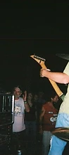Guitarist in a green shirt and black cowboy hat playing on stage at JescoFest 2006