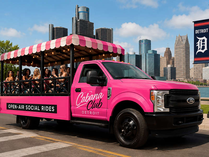 The pink open-air Cabana Club vehicle cruising through downtown Detroit with a crew having fun