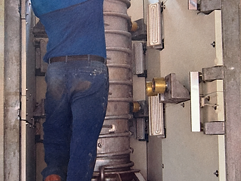 Technician assembling the vertical reactor column inside a modular housing