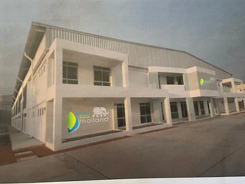Modern two-storey industrial facility with paved yard