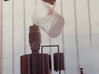 Technician pouring fluid into a pressurised vessel during testing