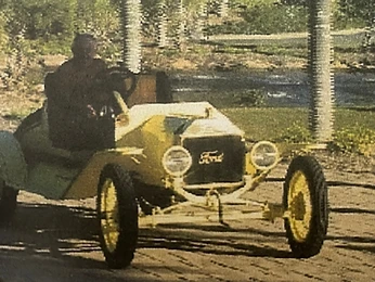 Vintage yellow Ford speedster being driven