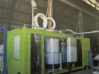 Lime-green containerised production unit with pressure vessel in a workshop