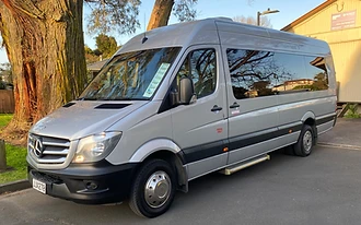 A silver Mercedes-Benz Sprinter passenger van parked on asphalt