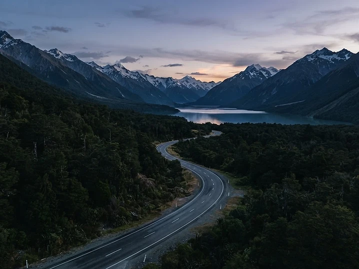 A quiet scenic New Zealand mountain road at dusk