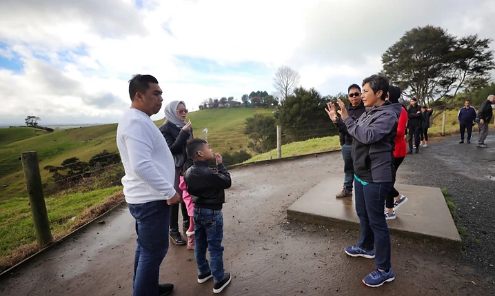 Tania guiding a private tour group at a scenic New Zealand overlook