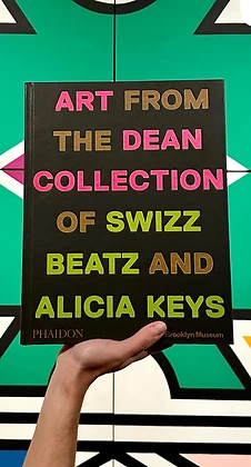The Giants catalogue by Phaidon held before an Ndebele wall, 2024