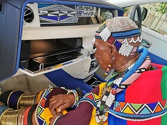 Dr Esther Mahlangu seated in the Rolls-Royce Phantom, viewing the bespoke Gallery dashboard artwork